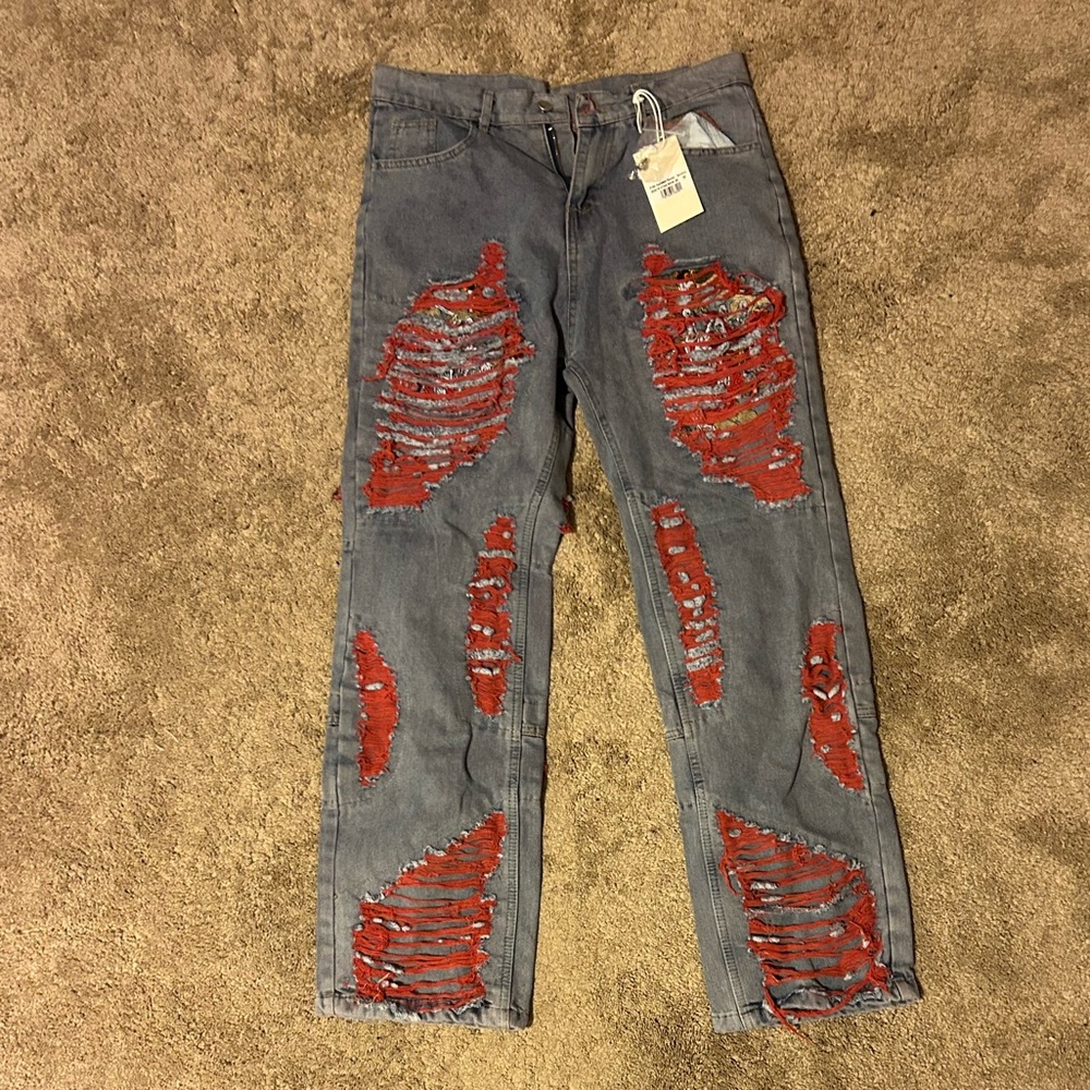 Red distressed blue baggy blue jeans